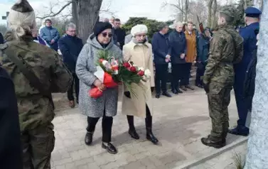 dwie osoby, wiązanka kwiat&oacute;w 